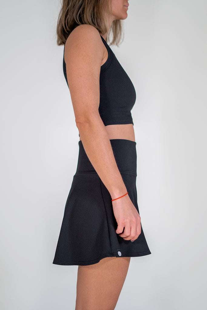 black tennis outfit with crop top and skirt side view